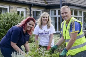 Tania Baugh, Quantity Surveyor (left) and Glen Doran, Safety Health Environment and Quality Advisor with United Living North, transform a care home garden with Kathy Markwick, Community Development Officer with Home Instead, during last year’s community day.