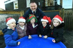 Geoff Scott, Social and Economic Impact Manager with Keepmoat Homes with children from Collierley Primary School